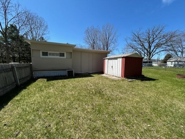 rear view of house featuring a storage shed and an outbuilding