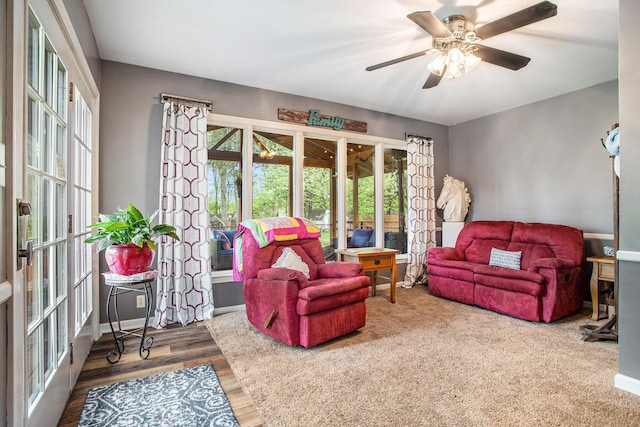 living room featuring french doors, a ceiling fan, and wood finished floors