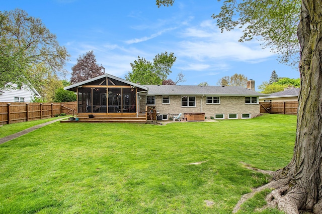 back of property featuring a sunroom, a chimney, brick siding, and a patio area