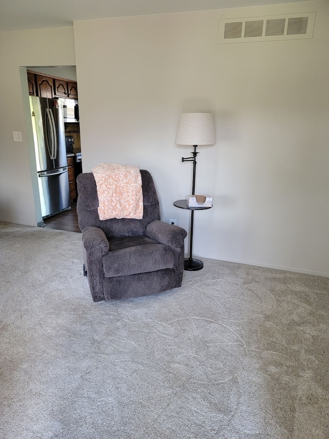 living area with dark carpet