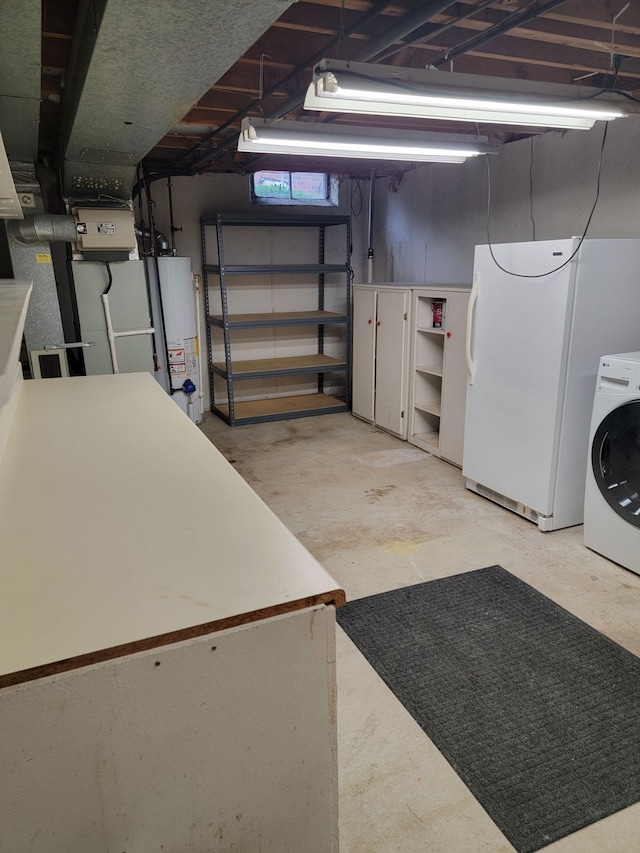 unfinished below grade area with washer / clothes dryer, water heater, and freestanding refrigerator