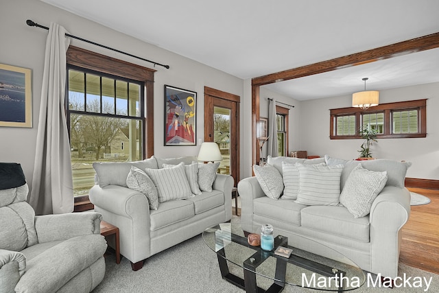 625 Leonard St NE, Grand Rapids, MI 49503 - living room featuring baseboards, wood finished floors, and beam ceiling