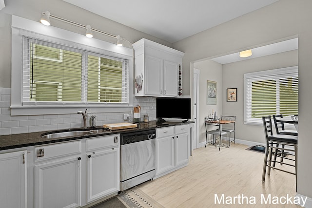 625 Leonard St NE, Grand Rapids, MI 49503 - kitchen featuring stainless steel dishwasher, a sink, decorative backsplash, and white cabinets