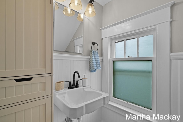 625 Leonard St NE, Grand Rapids, MI 49503 - bathroom featuring a sink, a decorative wall, and a wainscoted wall