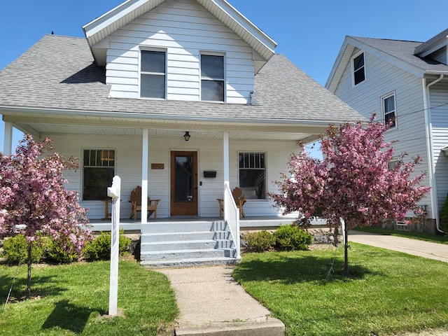 625 Leonard St NE, Grand Rapids, MI 49503 - bungalow-style house featuring roof with shingles, a porch, and a front yard