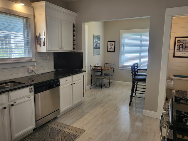 625 Leonard St NE, Grand Rapids, MI 49503 - kitchen featuring stainless steel dishwasher, plenty of natural light, backsplash, and light wood-type flooring