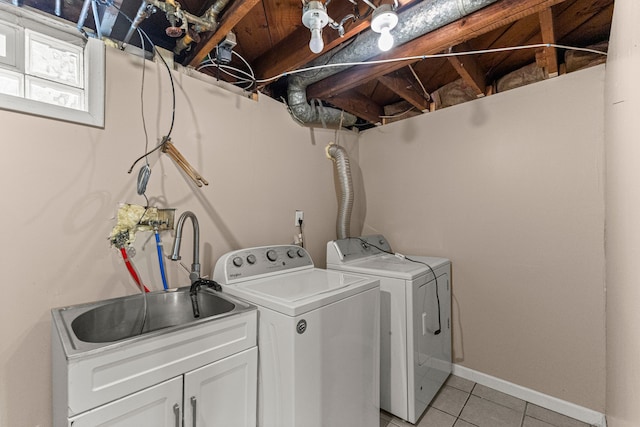 18310 Harman St, Melvindale, MI 48122 - washroom featuring separate washer and dryer, light tile patterned flooring, cabinet space, and baseboards