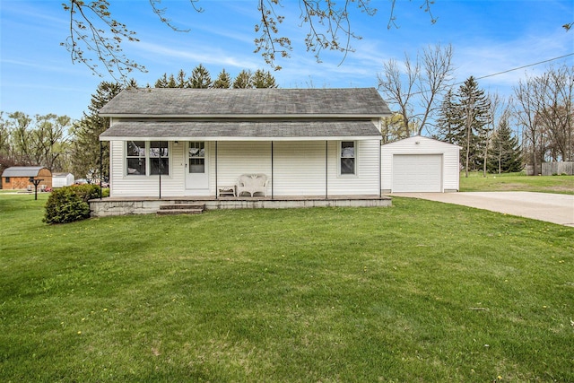 185 S Madison Ave, Custer, MI 49405 - view of front of property featuring covered porch, an outdoor structure, concrete driveway, a front lawn, and roof with shingles