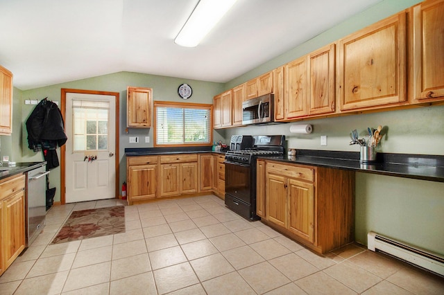 185 S Madison Ave, Custer, MI 49405 - kitchen featuring stainless steel appliances, a baseboard heating unit, vaulted ceiling, light tile patterned flooring, and dark countertops