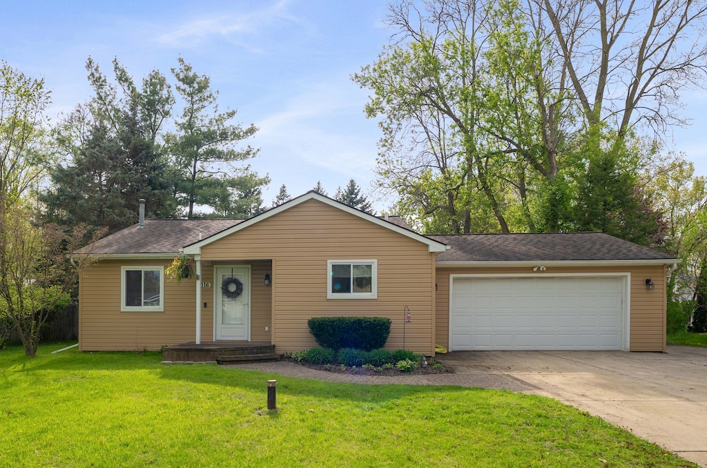 1116 Fairview St, White Lake, MI 48386 - view of front of home with driveway, an attached garage, a front lawn, and a shingled roof