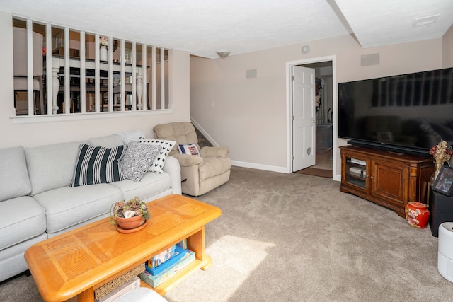 living room with stairway, carpet flooring, and baseboards