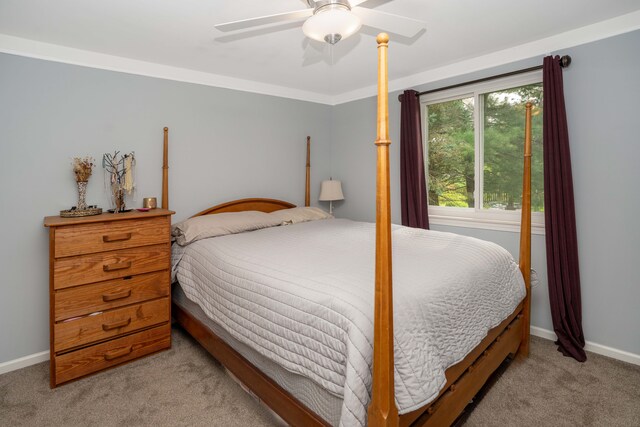 carpeted bedroom with baseboards and a ceiling fan