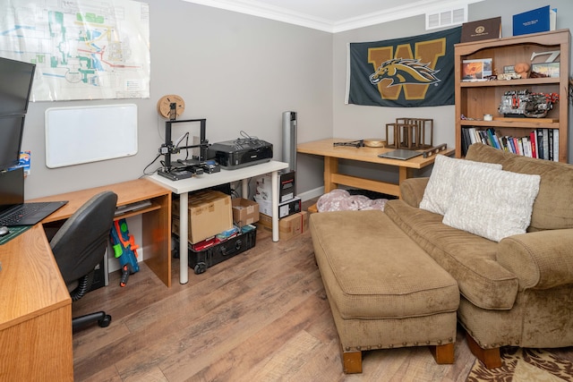 office featuring ornamental molding, wood finished floors, and baseboards