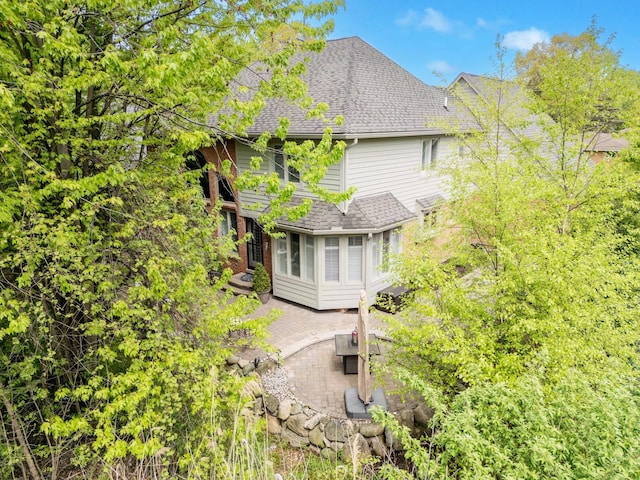 28022 Ashland Ave, Harrison Township, MI 48045 - view of home's exterior featuring a patio and a shingled roof
