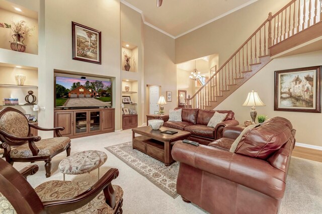 28022 Ashland Ave, Harrison Township, MI 48045 - carpeted living room with built in shelves, a high ceiling, ornamental molding, baseboards, and a chandelier