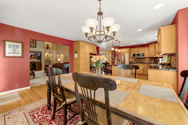 28022 Ashland Ave, Harrison Township, MI 48045 - dining area featuring light wood finished floors, a chandelier, baseboards, and recessed lighting