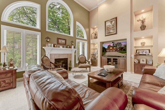 28022 Ashland Ave, Harrison Township, MI 48045 - living room featuring built in features, light carpet, a high ceiling, healthy amount of natural light, and a fireplace