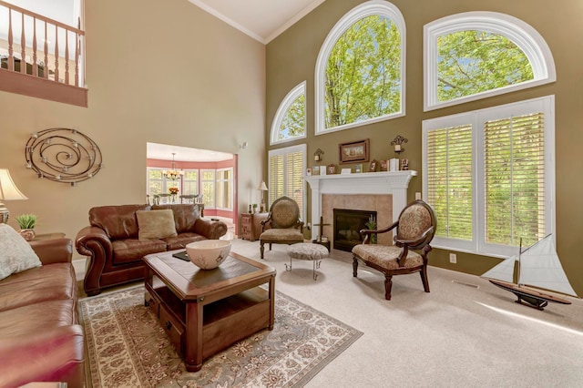 28022 Ashland Ave, Harrison Township, MI 48045 - carpeted living area featuring ornamental molding, a high ceiling, plenty of natural light, a chandelier, and a tile fireplace
