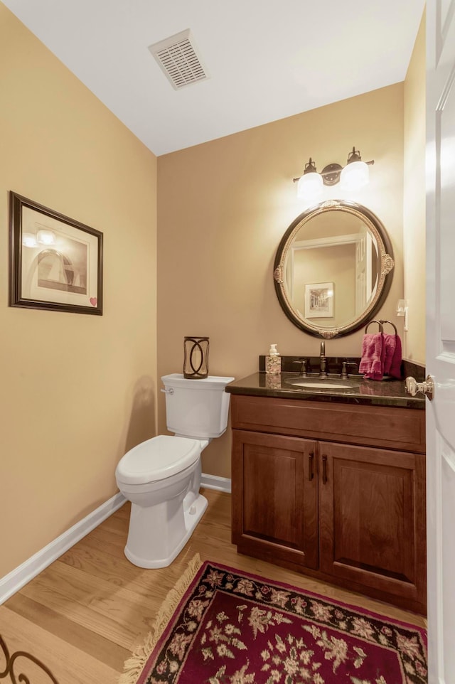28022 Ashland Ave, Harrison Township, MI 48045 - bathroom with wood finished floors, baseboards, vanity, and toilet