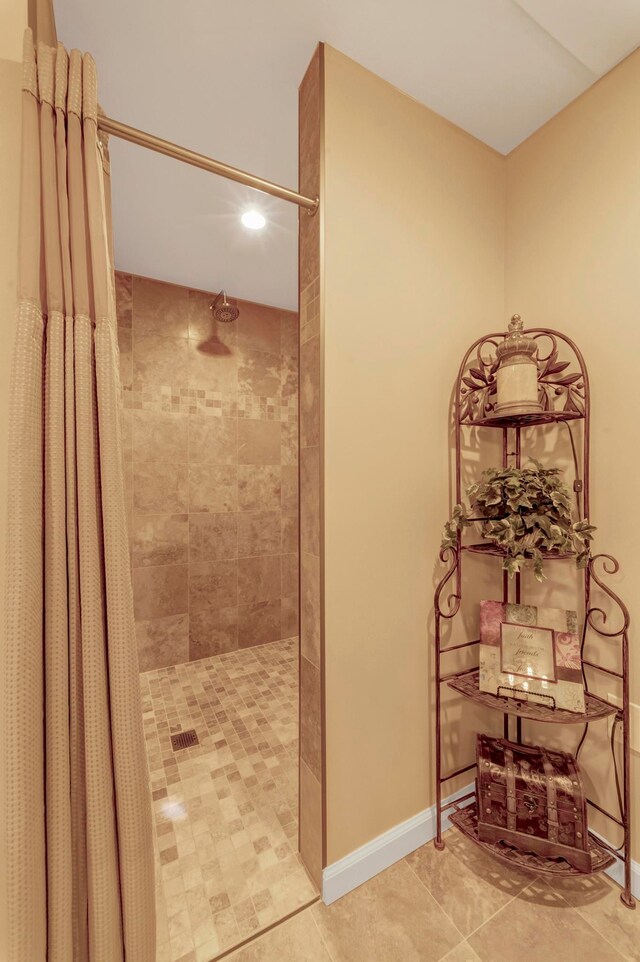 28022 Ashland Ave, Harrison Township, MI 48045 - bathroom featuring a tile shower, tile patterned flooring, and baseboards