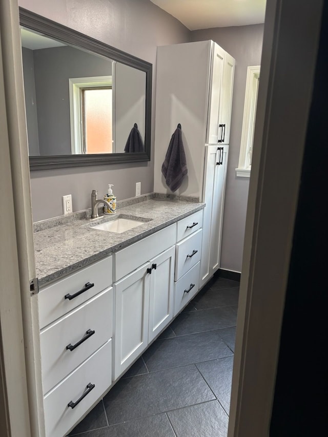 bathroom with tile patterned floors and vanity