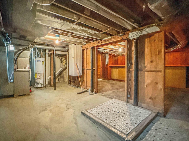 unfinished basement featuring gas water heater