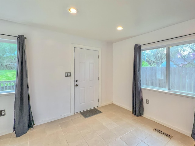 entryway with recessed lighting, baseboards, and light tile patterned flooring