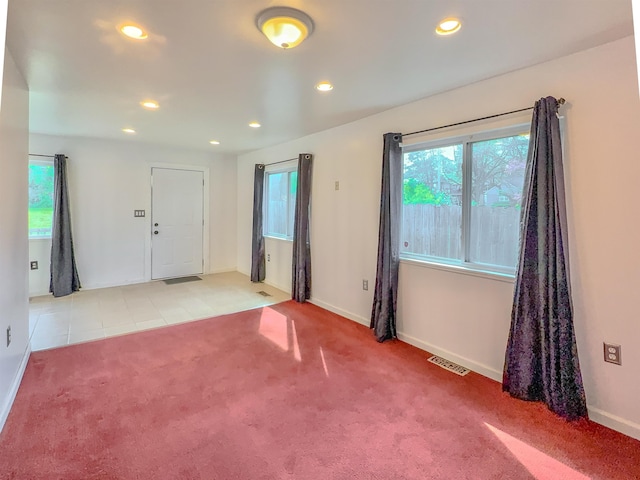 spare room featuring healthy amount of natural light, carpet flooring, baseboards, and recessed lighting