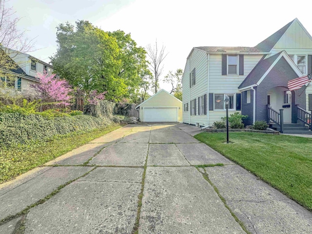 view of front of property featuring a detached garage, an outdoor structure, and a front lawn