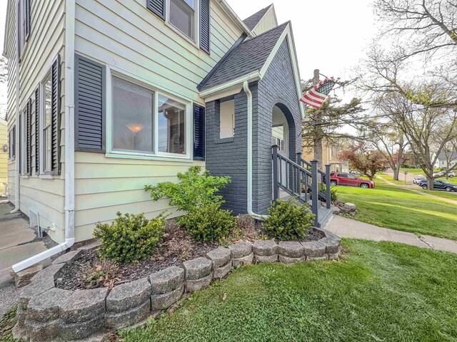 view of home's exterior featuring a yard and brick siding