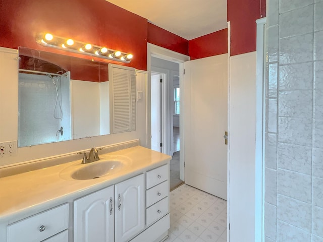 bathroom featuring tile patterned floors, a shower, and vanity