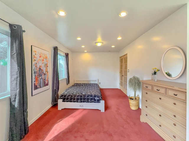 carpeted bedroom featuring multiple windows, recessed lighting, and baseboards