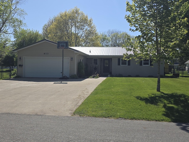 ranch-style home with a garage, concrete driveway, and metal roof