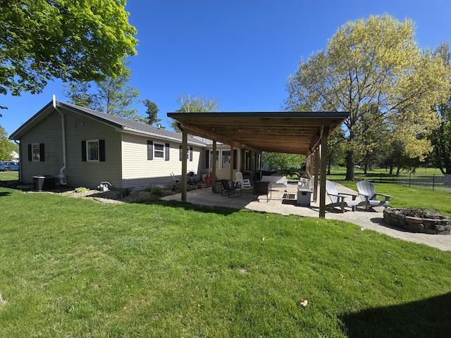 view of yard with a fire pit, a patio, and central AC unit