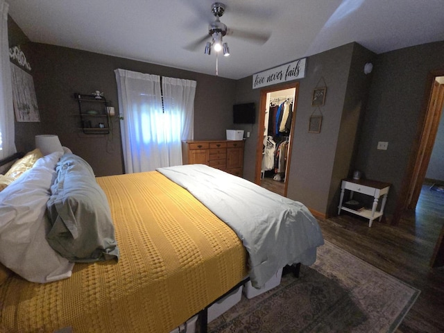 bedroom with wood finished floors, multiple windows, and a closet