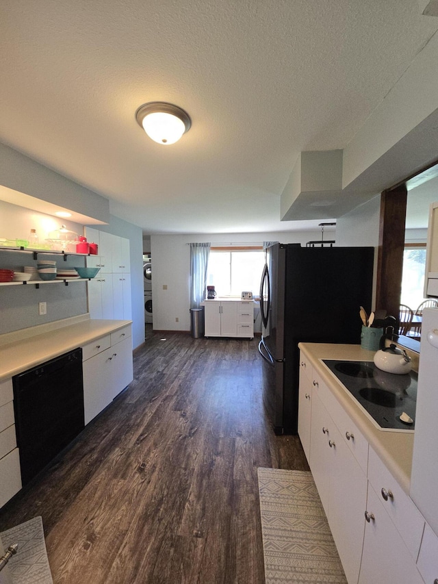 kitchen featuring dark wood-style flooring, white cabinets, light countertops, and a textured ceiling