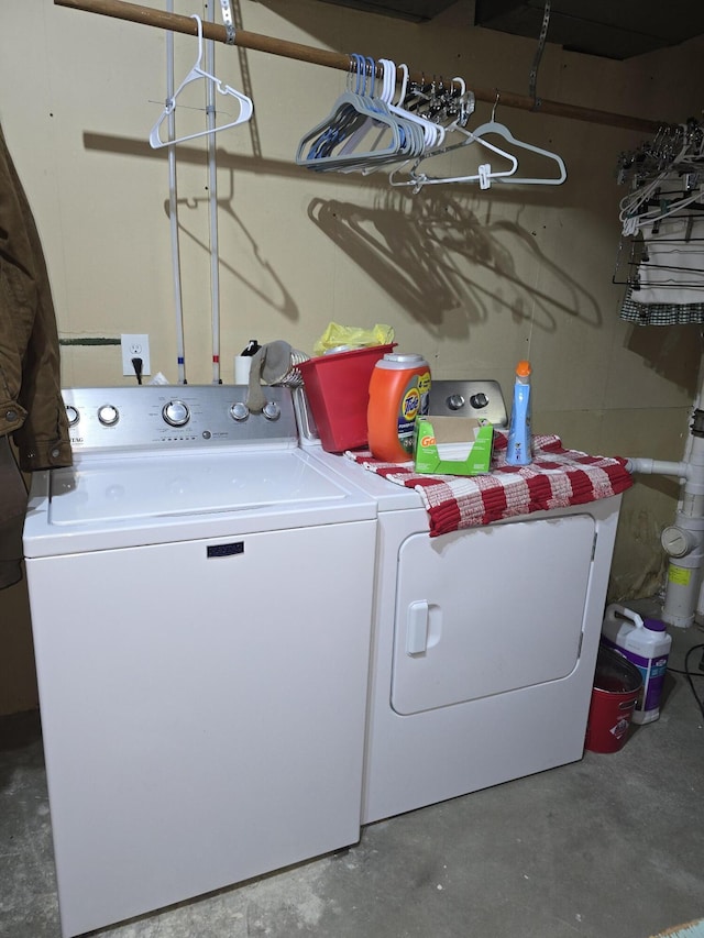 clothes washing area with washer and clothes dryer