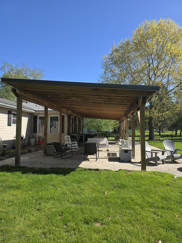 view of property's community with a patio and a lawn