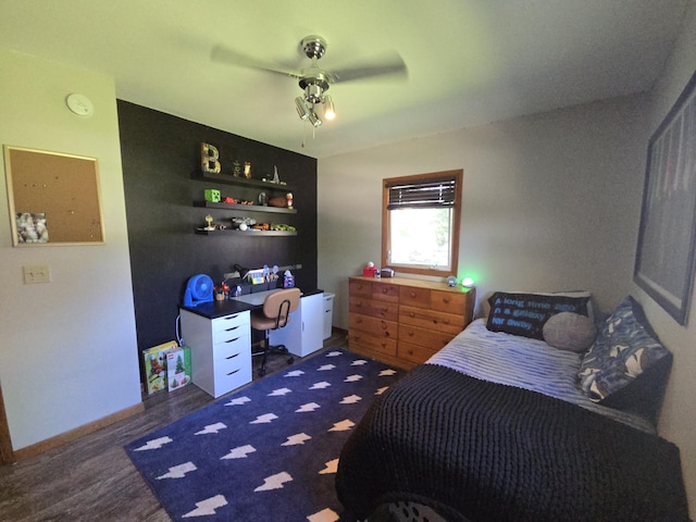 bedroom with a desk, wood finished floors, ceiling fan, and baseboards
