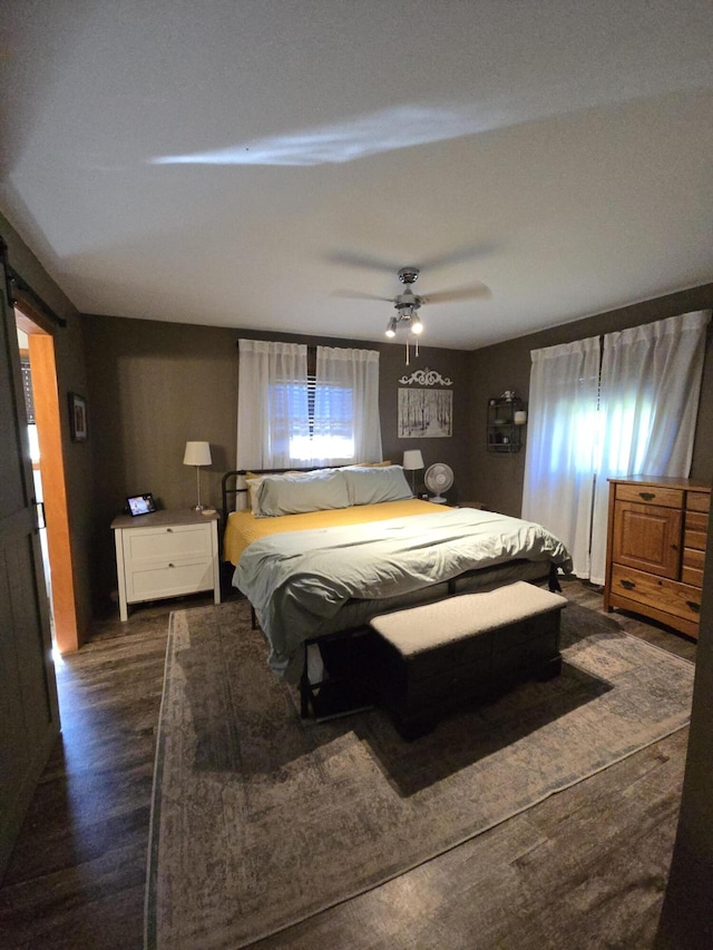 bedroom with dark wood-type flooring and a ceiling fan