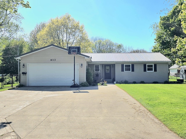 ranch-style house with a garage, concrete driveway, and metal roof