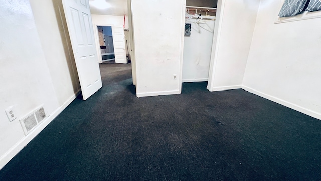 13646 Ryan Rd, Hamtramck, MI 48212 - unfurnished bedroom featuring baseboards, dark carpet, and a closet