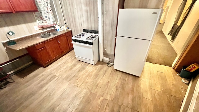 13646 Ryan Rd, Hamtramck, MI 48212 - kitchen featuring white appliances, light wood-type flooring, a sink, and brown cabinets
