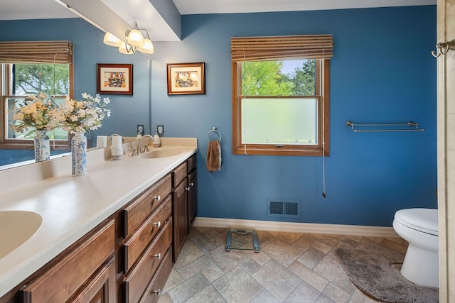 34570 Navin Ct, Livonia, MI 48152 - full bathroom featuring baseboards, healthy amount of natural light, double vanity, and stone finish flooring
