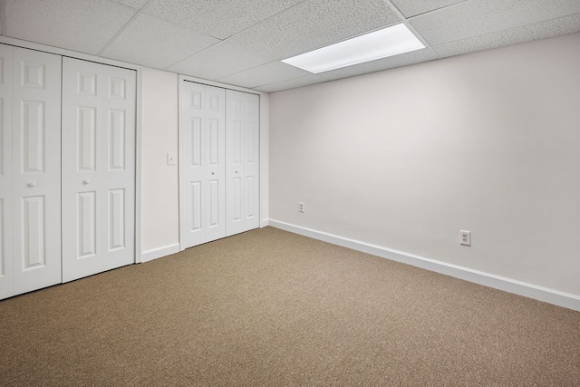 34570 Navin Ct, Livonia, MI 48152 - unfurnished bedroom featuring carpet floors, baseboards, a paneled ceiling, and two closets