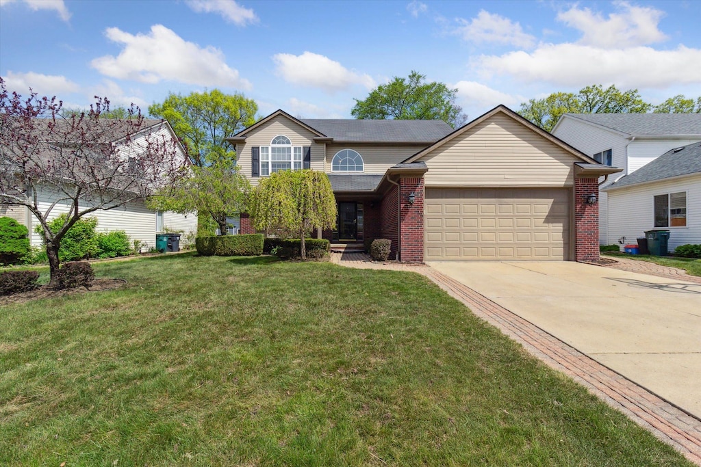 1339 Hartland Dr, Troy, MI 48083 - view of front facade with a garage, concrete driveway, brick siding, and a front yard