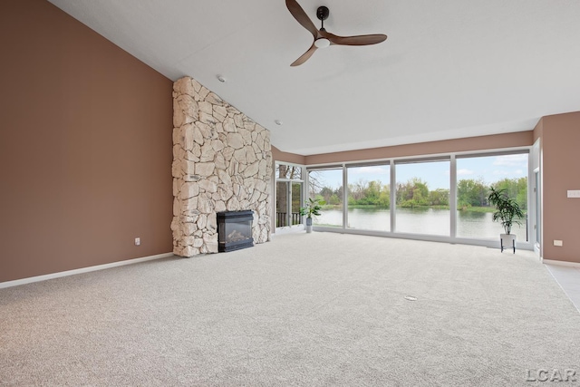 unfurnished living room with a water view, a ceiling fan, carpet, and high vaulted ceiling