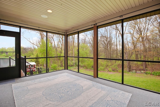 unfurnished sunroom featuring carpet floors and recessed lighting