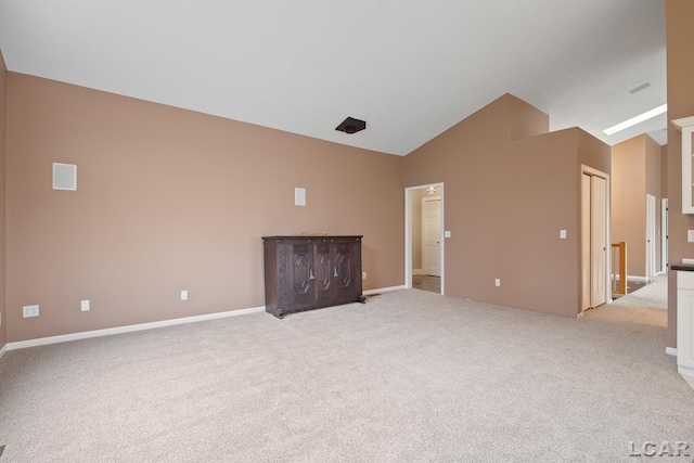 unfurnished living room featuring light colored carpet, high vaulted ceiling, and baseboards