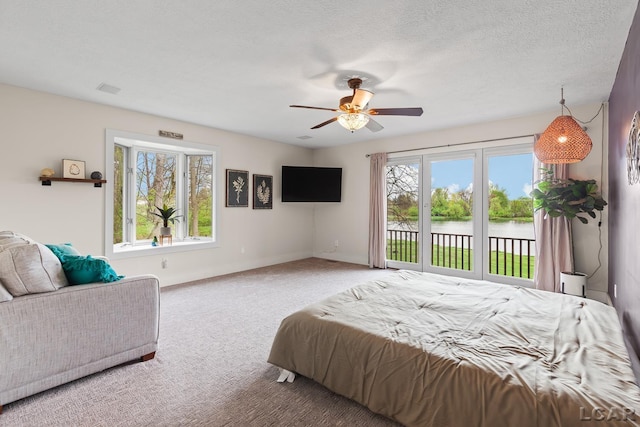 carpeted bedroom featuring multiple windows, access to outside, baseboards, and ceiling fan